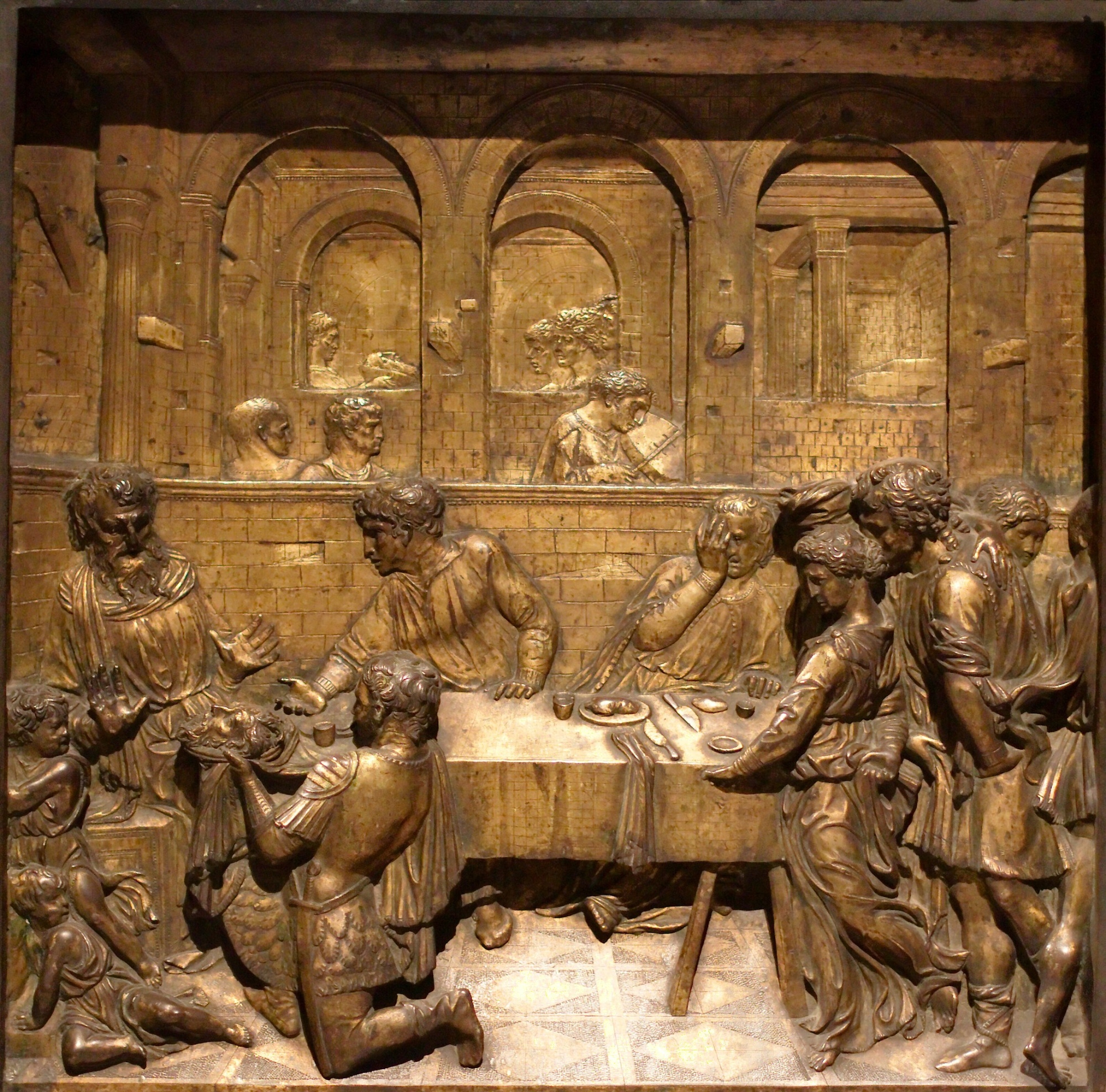 Herod's Banquet by Donatello on the Baptismal font in the San Giovanni Baptistery, Siena